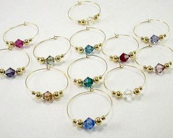 12 swarovski crystal wine glass charms accented with 2mm and 4mm gold beads by Vino Charm